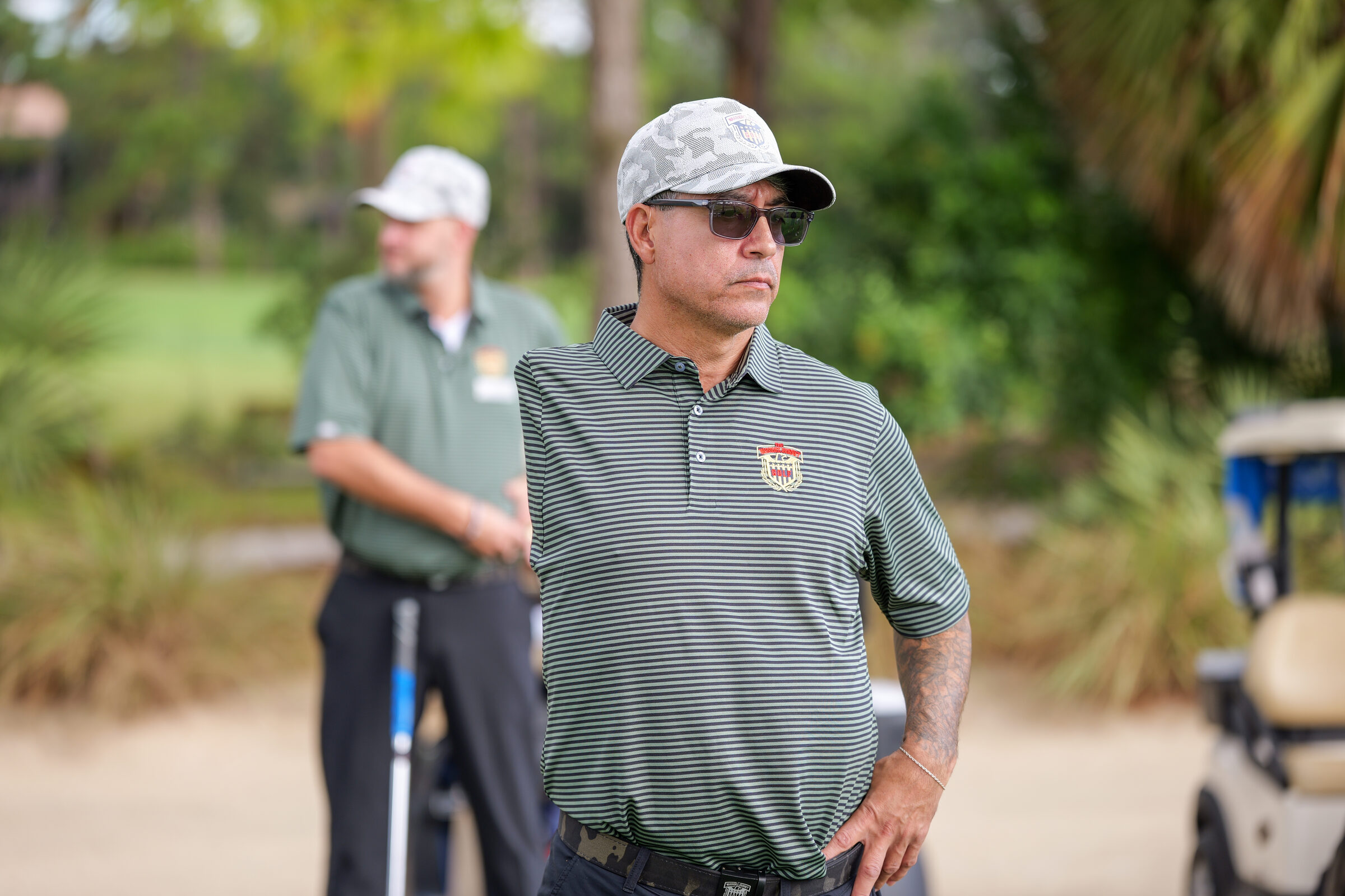 A veteran standing alone on the golf course in a quiet moment