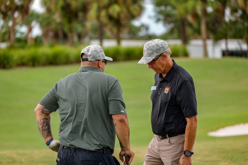 Two men walking together on a golf course